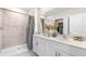 Modern bathroom featuring a double vanity, a tiled shower, and neutral color palette at 4911 Schubert Trl, North Port, FL 34287
