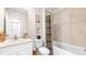 Well-lit bathroom featuring a shower-tub combo with a patterned curtain and a white vanity at 4911 Schubert Trl, North Port, FL 34287