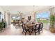 Elegant dining area with a modern chandelier, and views of the back yard at 4911 Schubert Trl, North Port, FL 34287