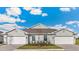 Charming home featuring a well manicured lawn, a lovely tree, and two-car garages at 4911 Schubert Trl, North Port, FL 34287