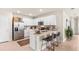 Modern kitchen featuring stainless steel appliances, an island with seating, and ample cabinet space at 4911 Schubert Trl, North Port, FL 34287