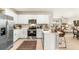 Bright kitchen showcasing stainless steel appliances, white cabinets, and an open concept layout at 4911 Schubert Trl, North Port, FL 34287