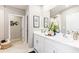 Elegant bathroom with double sinks, white cabinets, and decor at 4967 Tuscola Blvd, North Port, FL 34287