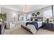 Well-lit bedroom with a luxurious bed, accent wall decorations, and a large window at 4967 Tuscola Blvd, North Port, FL 34287