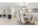 Elegant dining room with glass table, seating for six, and a modern chandelier at 4967 Tuscola Blvd, North Port, FL 34287