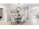 Dining room features modern lighting, elegant table setting, and easy access to the bathroom and kitchen at 4967 Tuscola Blvd, North Port, FL 34287