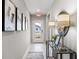 Inviting hallway features light gray walls, decorative wall art, and a stylish console table with lamps at 4967 Tuscola Blvd, North Port, FL 34287