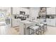 Modern kitchen with stainless steel appliances, white cabinets, and a center island with bar seating at 4967 Tuscola Blvd, North Port, FL 34287