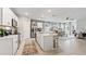 Bright kitchen and living area boasts stainless steel appliances, a breakfast bar, and an open layout at 4967 Tuscola Blvd, North Port, FL 34287