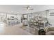 Open-concept living room features modern white kitchen, breakfast bar, and cozy seating area with stylish decor at 4967 Tuscola Blvd, North Port, FL 34287