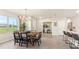 Cozy dining area featuring a wooden table with seating, and an open view to the kitchen at 5028 Schubert Trl, North Port, FL 34287
