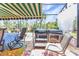 Inviting patio area featuring a hot tub, overhead awning, and comfortable seating at 5046 San Rocco Ct, Punta Gorda, FL 33950