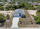 Aerial view of home with a long driveway and a three-car garage at 7149 Sea Mist Dr, Port Charlotte, FL 33981