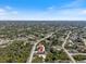 Aerial view of the property's location in a residential area with nearby trees and a creek at 7149 Sea Mist Dr, Port Charlotte, FL 33981