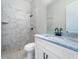 Bathroom with marble tile, vanity with black accents and a shower at 7149 Sea Mist Dr, Port Charlotte, FL 33981