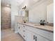 Bright bathroom with double vanity sinks, and a luxurious marble shower at 7149 Sea Mist Dr, Port Charlotte, FL 33981