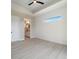 Neutral bedroom with a view into the bathroom, and a ceiling fan at 7149 Sea Mist Dr, Port Charlotte, FL 33981