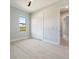 Bright bedroom with tile floors, a ceiling fan, and a double-door closet at 7149 Sea Mist Dr, Port Charlotte, FL 33981