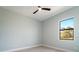 Well-lit bedroom with a ceiling fan and a view to the outside at 7149 Sea Mist Dr, Port Charlotte, FL 33981