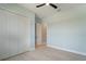 Bright bedroom with tile floors, a ceiling fan, and a double-door closet at 7149 Sea Mist Dr, Port Charlotte, FL 33981
