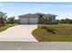 Front exterior with large driveway and lawn at 7149 Sea Mist Dr, Port Charlotte, FL 33981