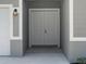 A close-up of the home's front door and exterior lighting at 7149 Sea Mist Dr, Port Charlotte, FL 33981