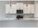 Modern kitchen features a spacious island, marble countertops, and stainless steel appliances, ideal for cooking enthusiasts at 7149 Sea Mist Dr, Port Charlotte, FL 33981
