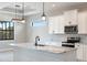 Bright kitchen features marble countertops, stainless steel appliances, and modern lighting at 7149 Sea Mist Dr, Port Charlotte, FL 33981
