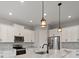 Well-lit kitchen showcasing stainless steel appliances, marble counters and white cabinetry at 7149 Sea Mist Dr, Port Charlotte, FL 33981