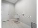 Laundry room with utility sink and white door at 7149 Sea Mist Dr, Port Charlotte, FL 33981