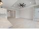Spacious, airy room features modern flooring, a shiplap accent wall, and a ceiling fan, perfect for comfortable living at 7149 Sea Mist Dr, Port Charlotte, FL 33981