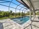 Enclosed pool area with a paved patio and screen for outdoor enjoyment at 7149 Sea Mist Dr, Port Charlotte, FL 33981