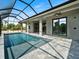 Screened-in pool with a view of lush greenery at 7149 Sea Mist Dr, Port Charlotte, FL 33981