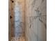 Modern shower featuring marble tile and a pebble floor at 7149 Sea Mist Dr, Port Charlotte, FL 33981