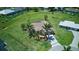 Wide aerial shot showing house on large lot with green grass, surrounded by other homes in the community at 7505 Carissa, Punta Gorda, FL 33955