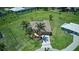 Expansive aerial view of home on a large lot, surrounded by green grass, and other houses nearby at 7505 Carissa, Punta Gorda, FL 33955