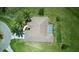 Aerial view of home featuring an enclosed pool, well-manicured lawn, and lush landscaping at 7505 Carissa, Punta Gorda, FL 33955