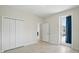 Spacious bedroom featuring a closet, doorway, and glass paneled exterior door covered by curtains at 7505 Carissa, Punta Gorda, FL 33955