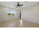 Bright bedroom with tile flooring, ceiling fan, and natural light from the window at 7505 Carissa, Punta Gorda, FL 33955