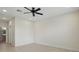 A bedroom featuring neutral walls, tile flooring, ceiling fan, and a bright window at 7505 Carissa, Punta Gorda, FL 33955