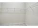 Walk-in closet with white wire shelving and neutral-colored walls and floor at 7505 Carissa, Punta Gorda, FL 33955
