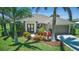 Inviting single-story home with lush landscaping, palm trees, and a well-maintained front lawn at 7505 Carissa, Punta Gorda, FL 33955