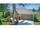 Attractive single-story home featuring tropical landscaping, lush lawn, and a two-car garage at 7505 Carissa, Punta Gorda, FL 33955