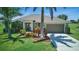 Beautiful single-story home with lush landscaping, vibrant plants, and a spacious two-car garage at 7505 Carissa, Punta Gorda, FL 33955