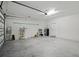 Spacious two car garage with white walls, concrete floor, and storage racks at 7505 Carissa, Punta Gorda, FL 33955