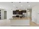Stylish kitchen boasts granite counters, stainless appliances, a center island, and modern pendant lighting at 7505 Carissa, Punta Gorda, FL 33955