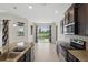 A view of the open kitchen showcasing granite counters, stainless appliances, and tile flooring at 7505 Carissa, Punta Gorda, FL 33955