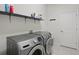 Laundry room with front-load washer and dryer and built in shelving at 7505 Carissa, Punta Gorda, FL 33955
