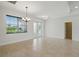 Bright living room with tile floors, natural light, and access to the outdoors at 7505 Carissa, Punta Gorda, FL 33955