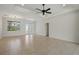 Sunlit living room with tile flooring, sliding glass doors to the outside, and an adjacent dining area at 7505 Carissa, Punta Gorda, FL 33955